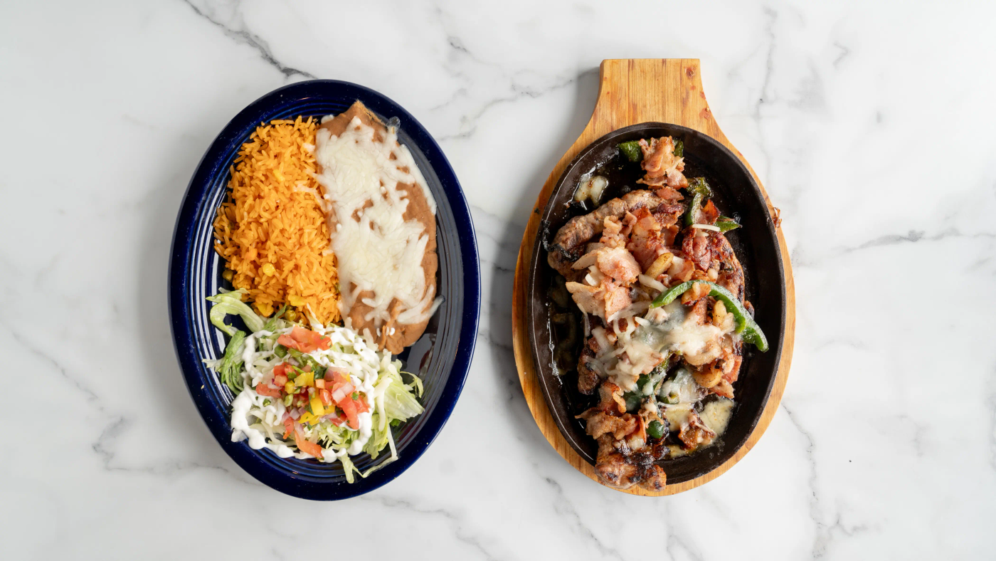 Ribeye steak cooked with bacon, poblano peppers, and cheese on top. Served with a side of rice, beans, lettuce, sour cream, tomato, and three flour or corn tortillas